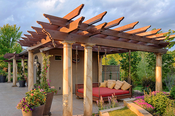 Pergola adorned pool house for entertaining and relaxation