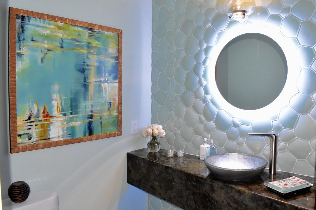 glass tiled accent wall with back-illuminated mirror