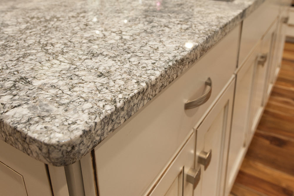 Granite counter top and white distressed cabinets