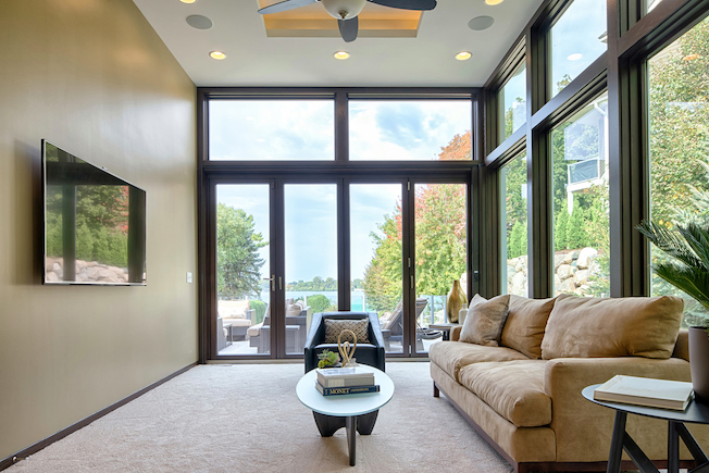 Contemporary Home Remodel - Living Room Featuring Moveable Glass Wall System - looking out to deck and lake