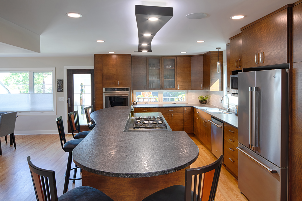 Modern kitchen with leathered granite countertop and custom light fixture