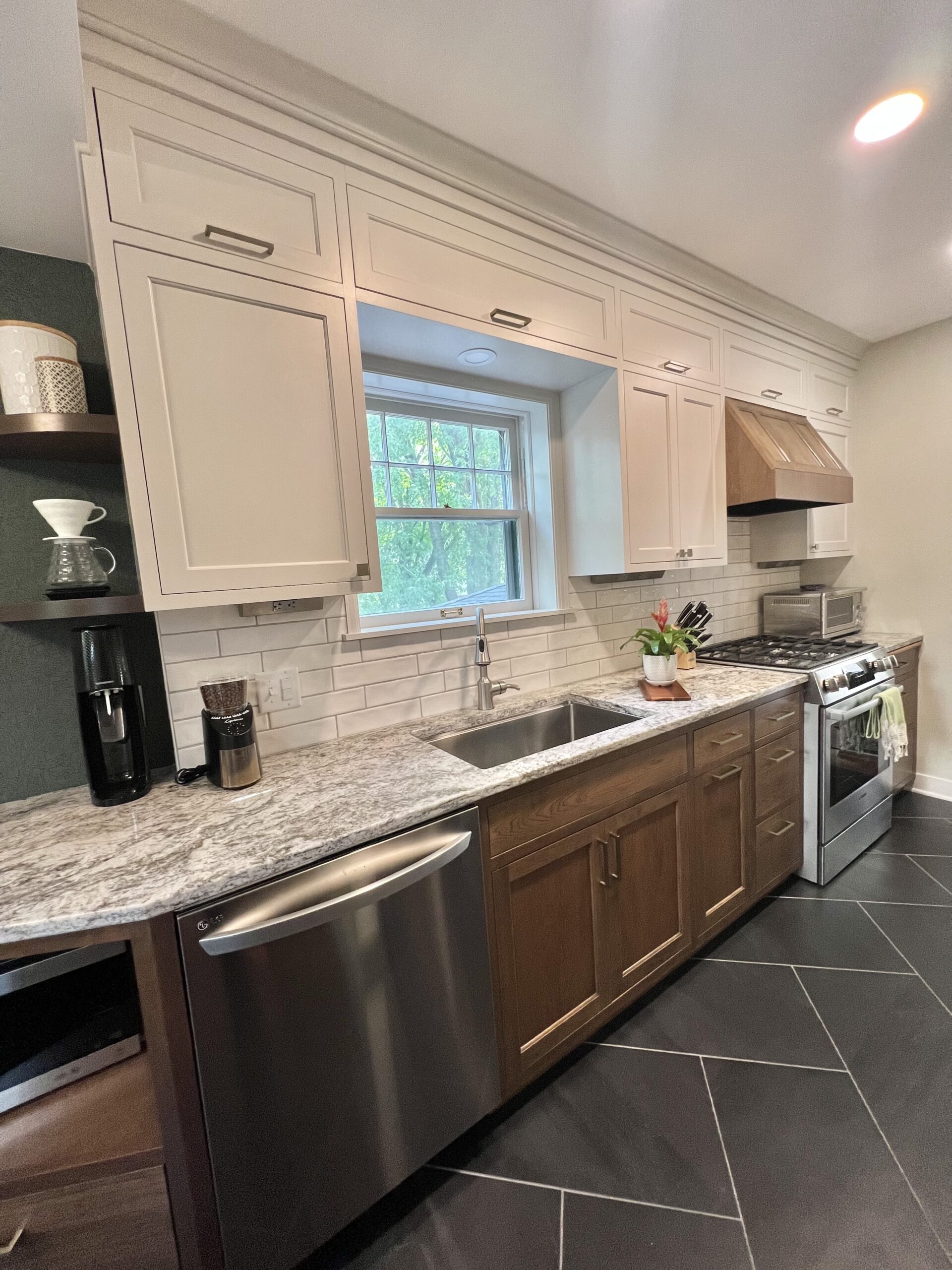 Galley kitchen - view of sink, countertops, dishwasher, range, microwave, and cabinets