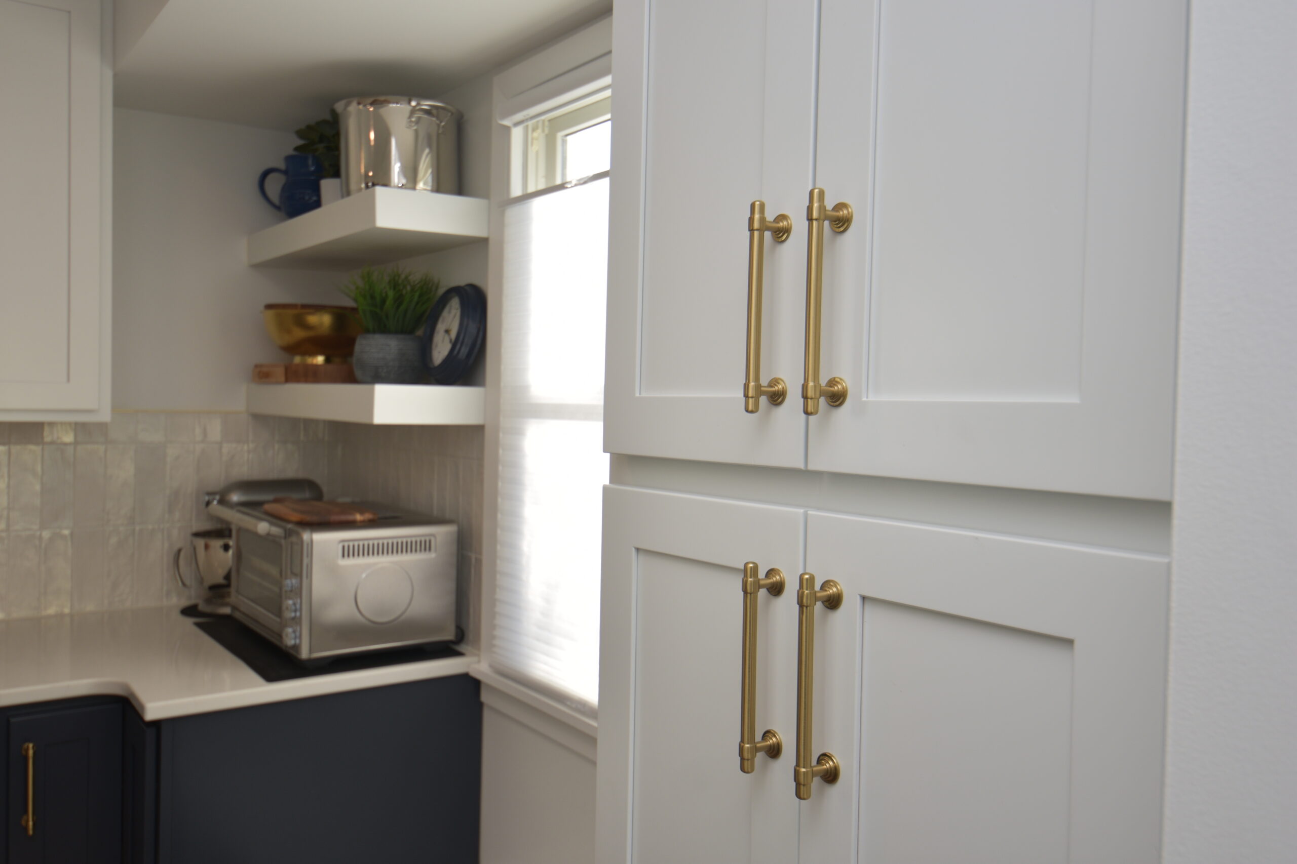 Navy blue galley kitchen - close up of white cabinetry