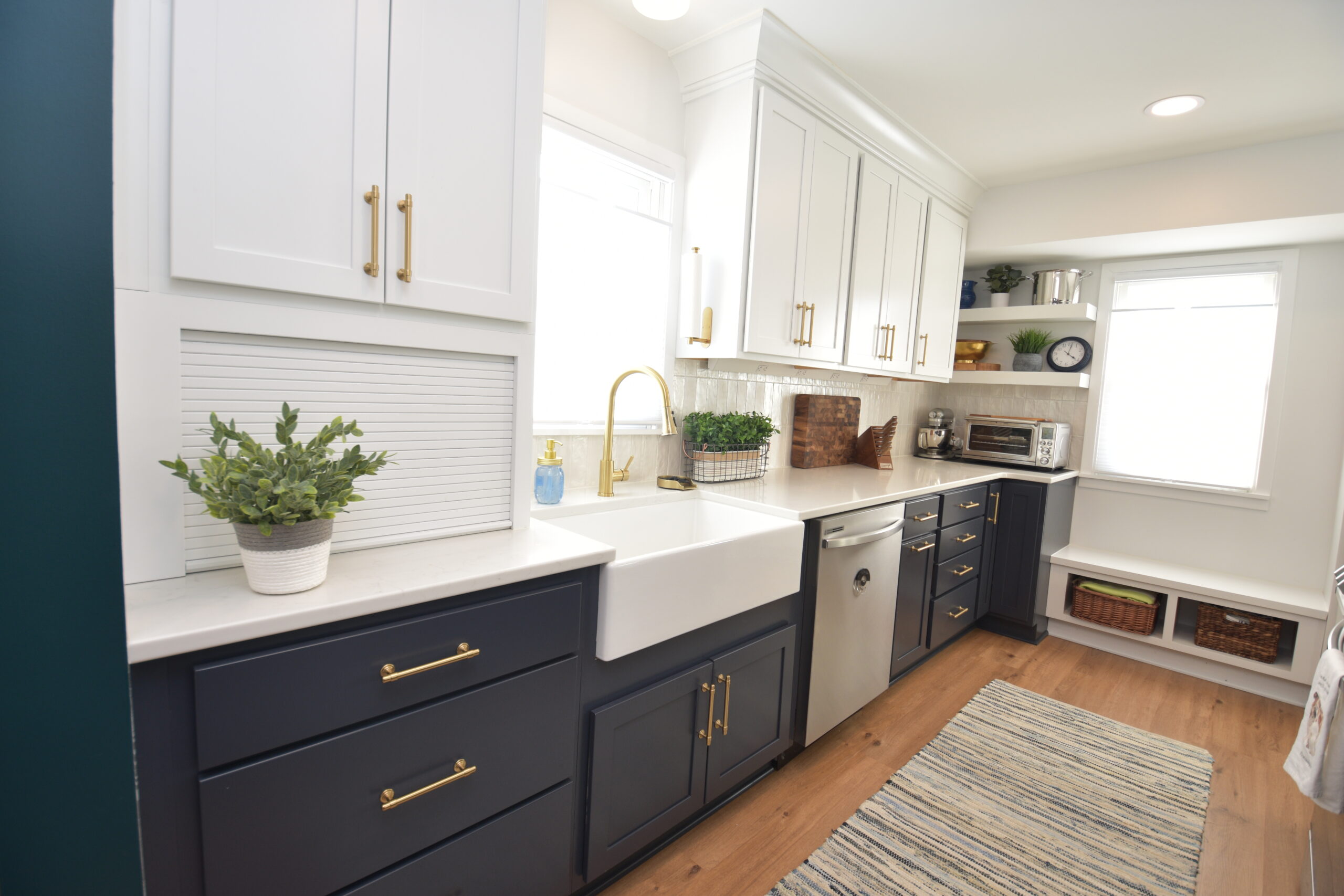 Navy blue galley kitchen - view of sink, cabinets, and dishwasher, and bench