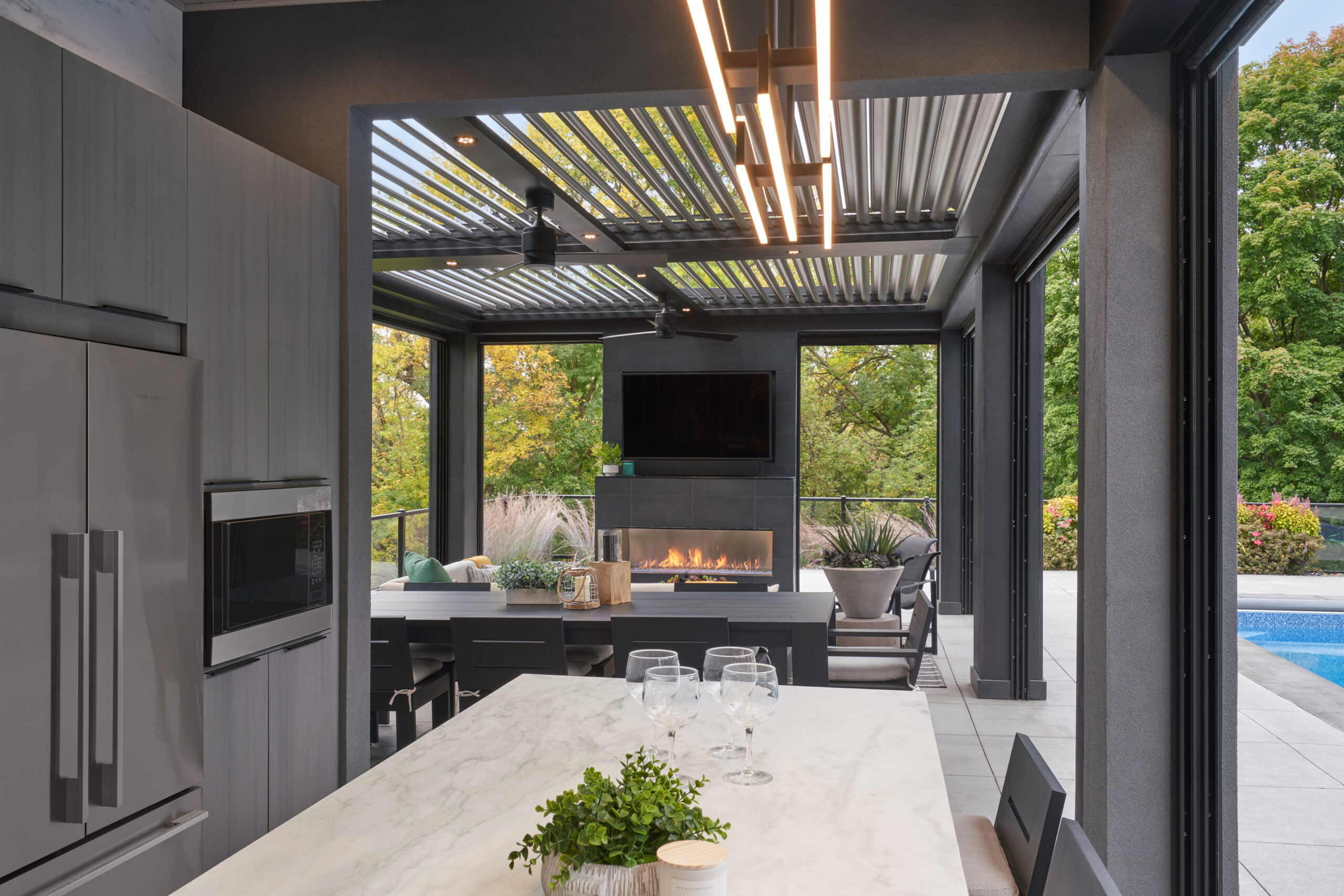 Contemporary outdoor kitchen - part of poolhouse project - Screens open.