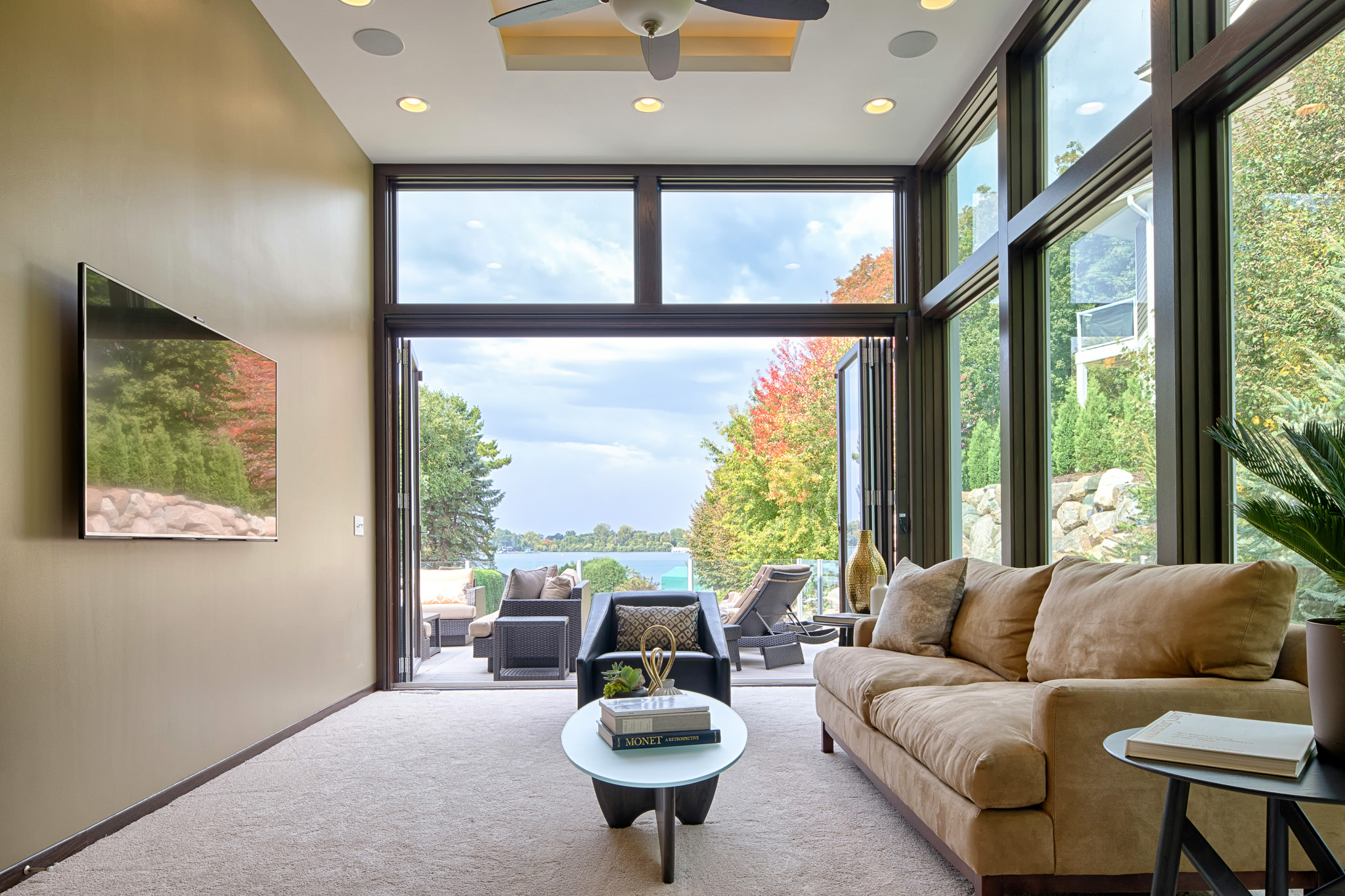 Contemporary Home Remodel - Living Room Featuring Moveable Glass Wall System - looking out to deck and lake