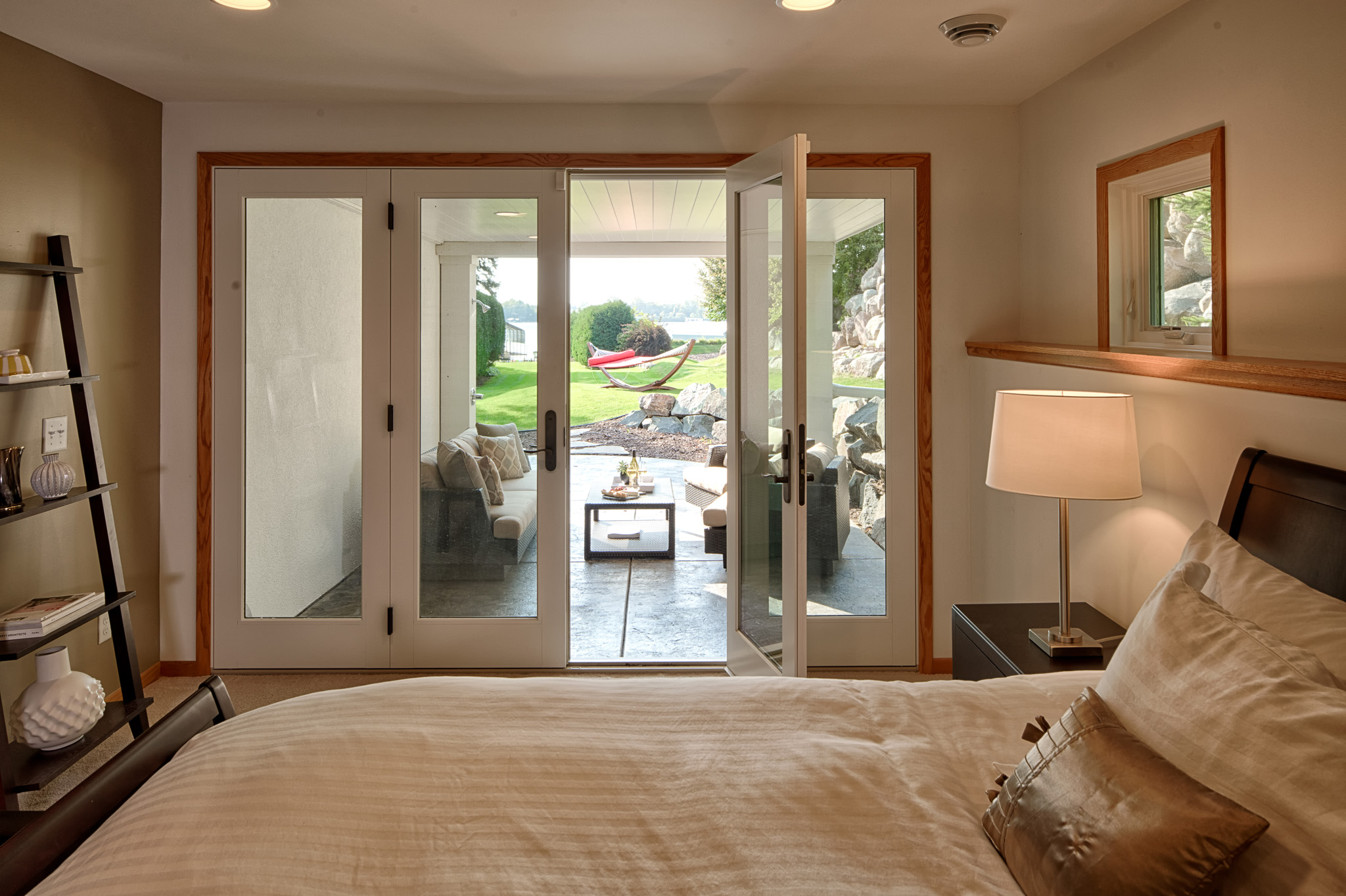 Contemporary Home Remodel - Downstairs Bedroom - Doors open to outside patio